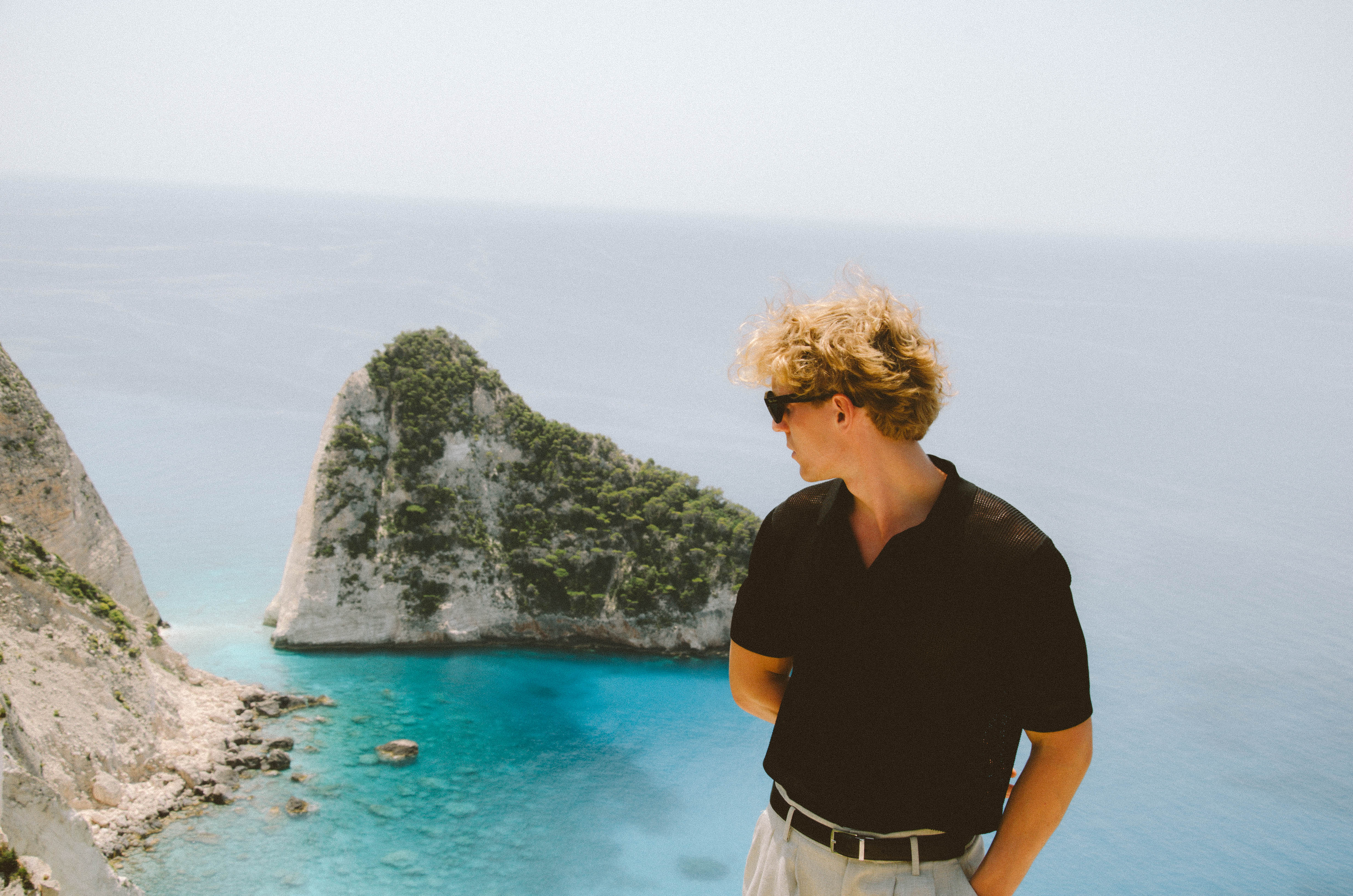 Person overlooking Mediterranean coastal cliffs